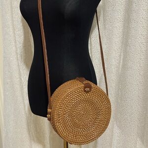 Round Woven Tan Crossbody Bag with Brown Leather Strap and Snap Closure